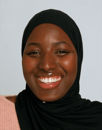 A portrait GIF of a female student laughing and smiling