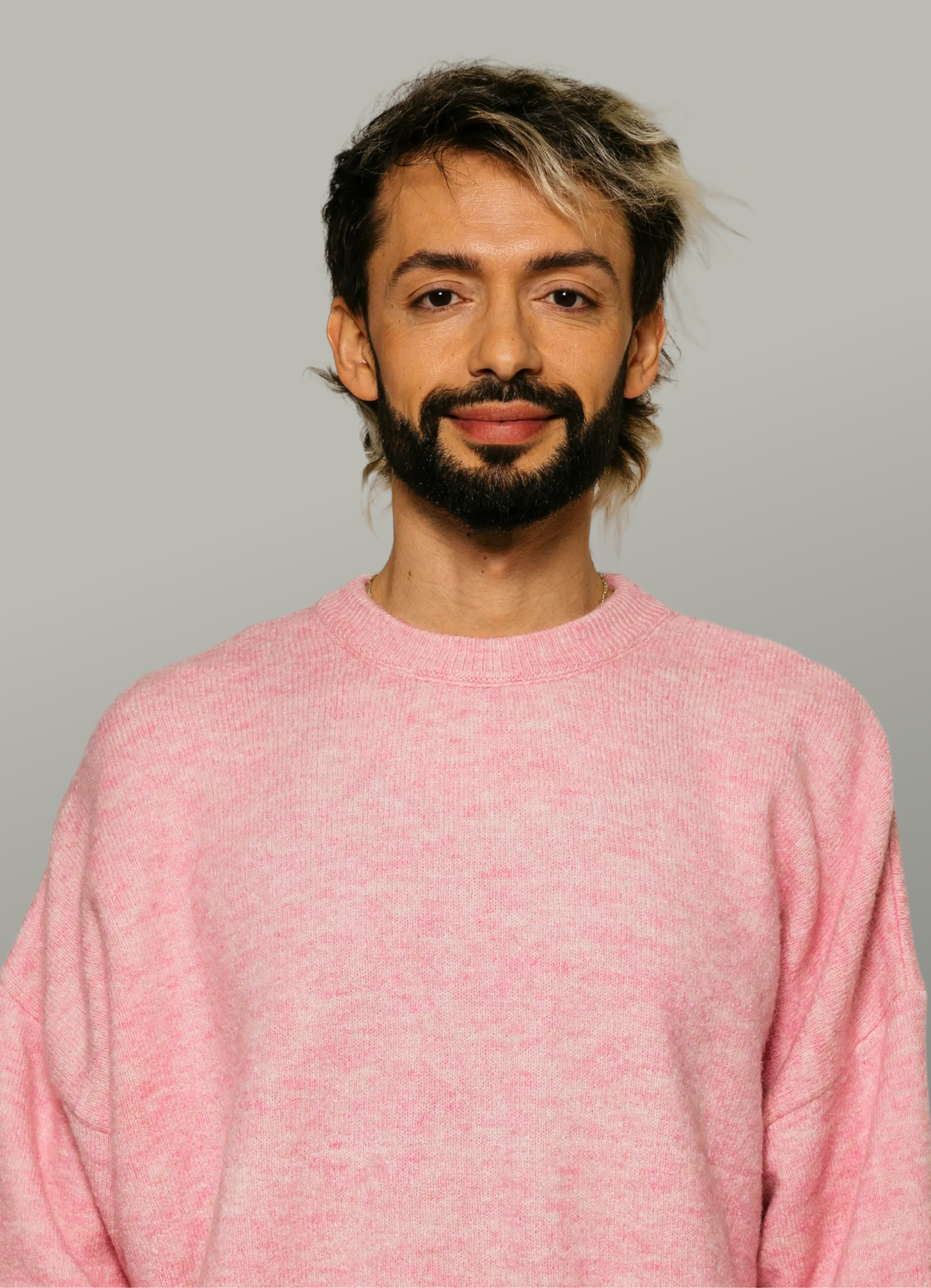 Portrait of a male tutor in a pink sweater