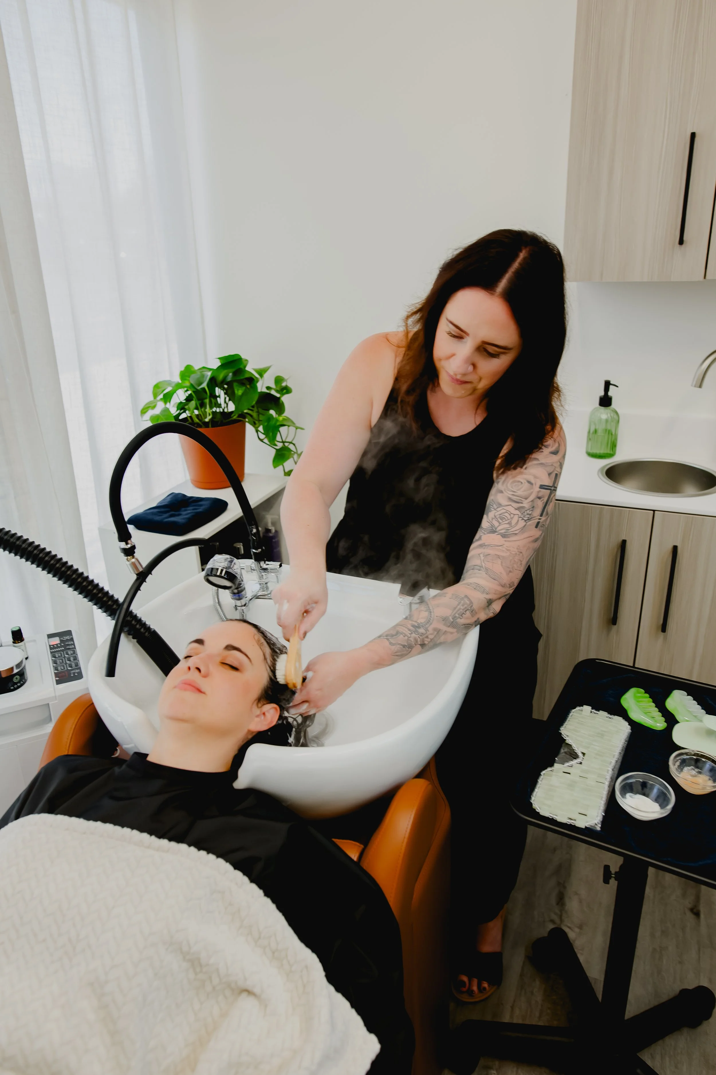 Scalp treatment with steam during a customized head spa at Connors Collective in North Phoenix, Arizona