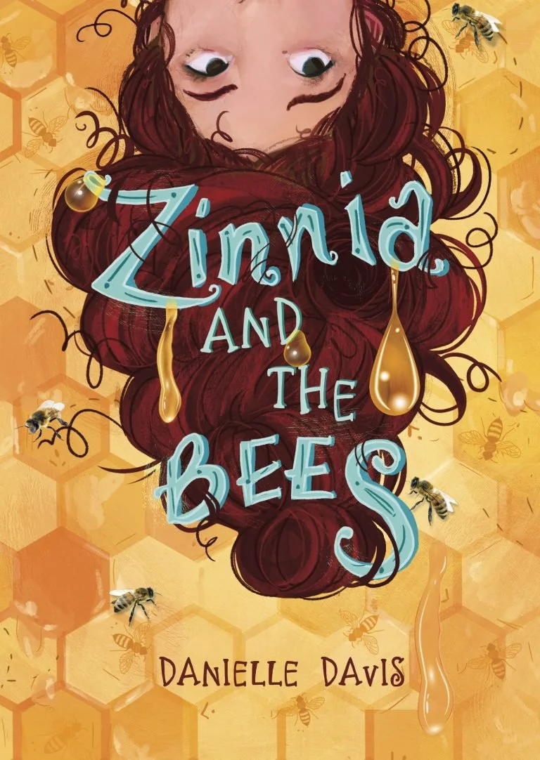 Book cover for "Zinnia and the Bees" by Danielle Davis, featuring a girl with long red hair and wide eyes, surrounded by honey drops and bees on a honeycomb background.