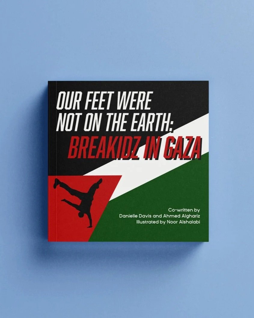 Book titled "Our Feet Were Not on the Earth: Breakidz in Gaza" co-written by Danielle Davis and Ahmed Algariz, illustrated by Noor Alshalabi, with a cover design featuring the colors of the Palestinian flag and a silhouette of a person doing a handstand in black.