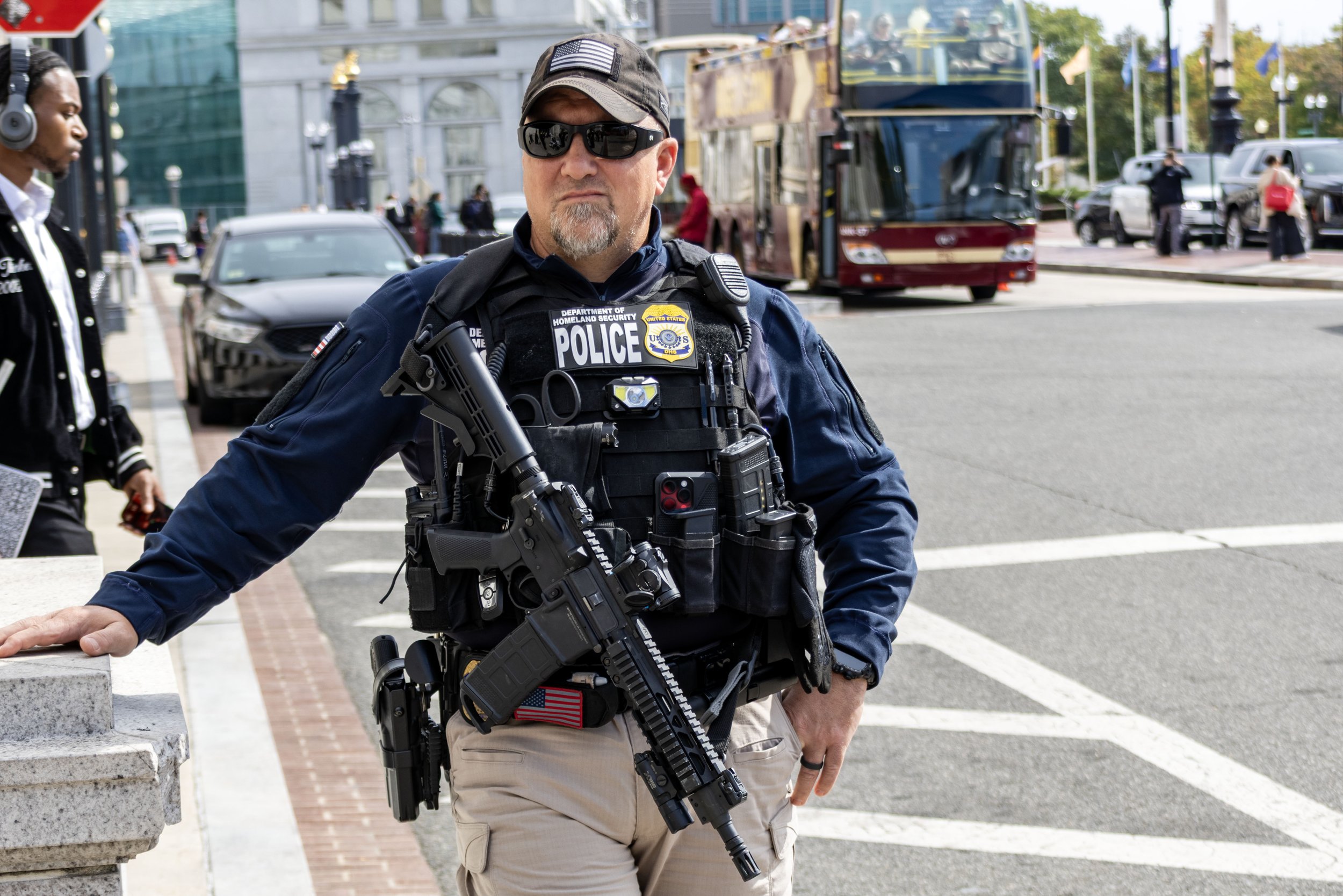 Armed DHS cop standing guard outside Union Station before the No Kings rally - October 18, 2025
