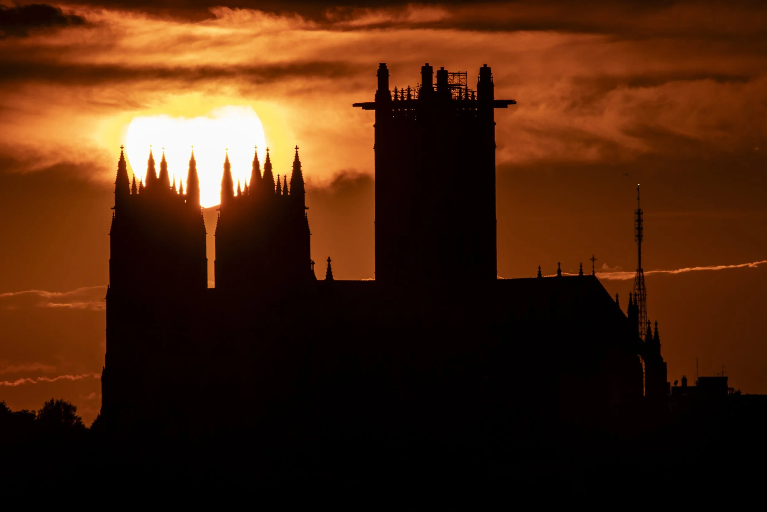Golden sun setting behind the National Cathedral - August 17, 2023