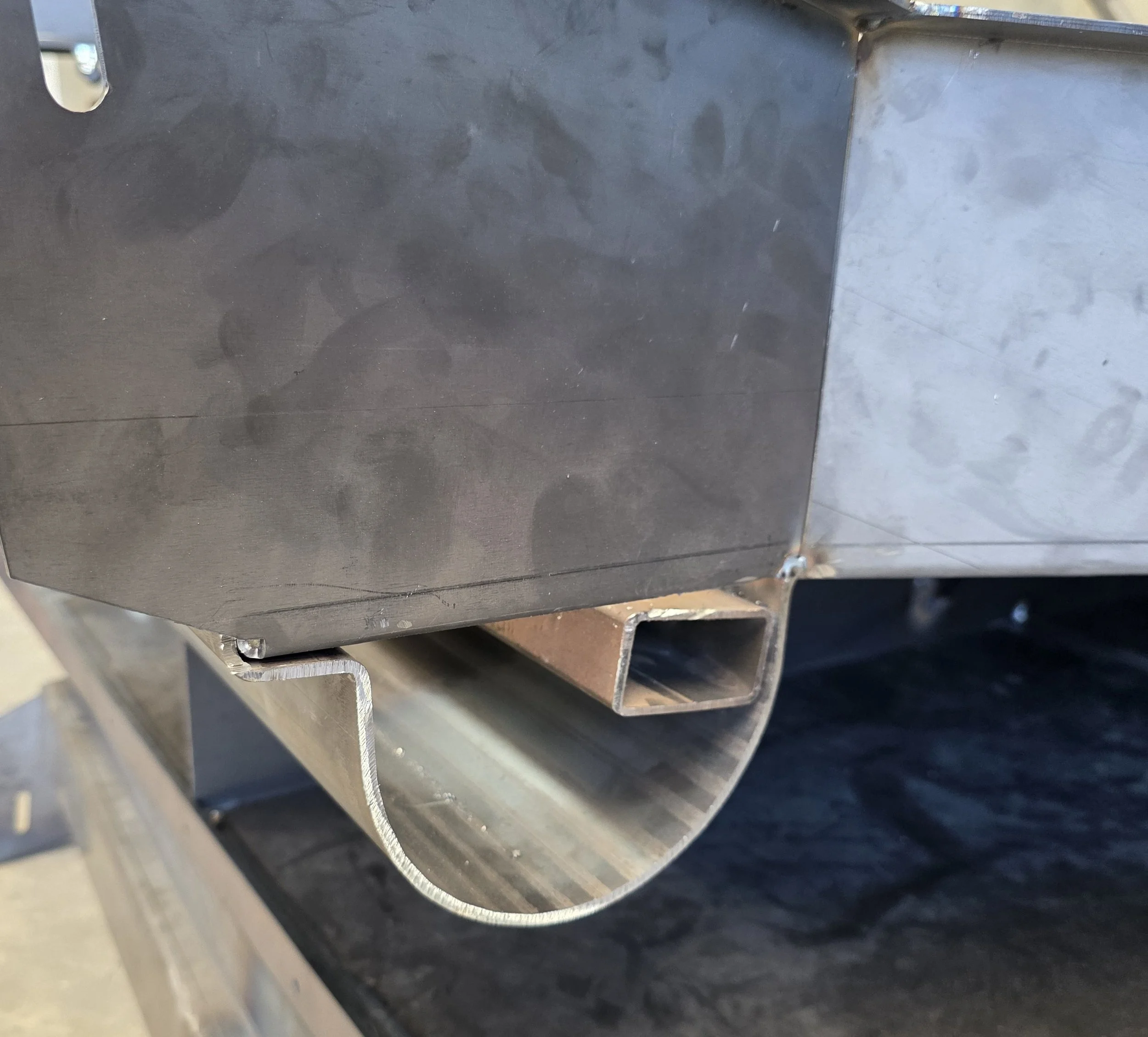 Close-up example of sheet metal being folded to create a round edge.