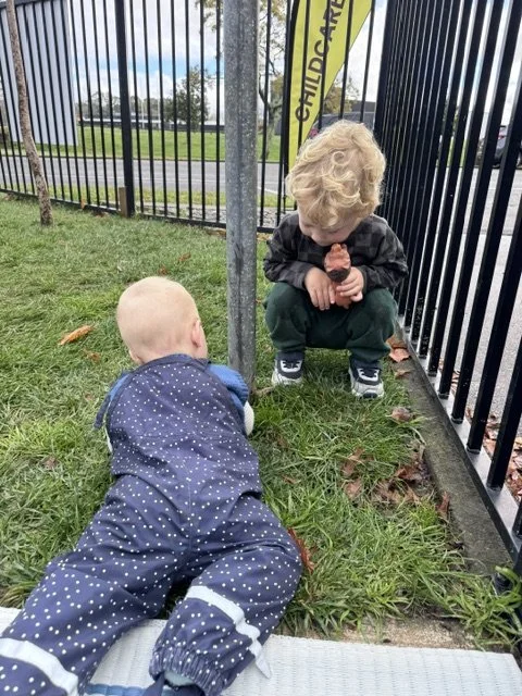 Older and younger children building caring relationships through shared outdoor experiences, encouraging empathy, confidence and a sense of belonging.