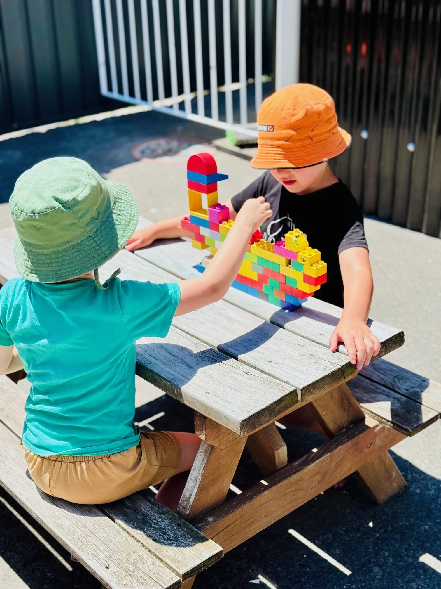 Children developing creativity, problem-solving and collaboration through hands-on construction play in an outdoor learning environment