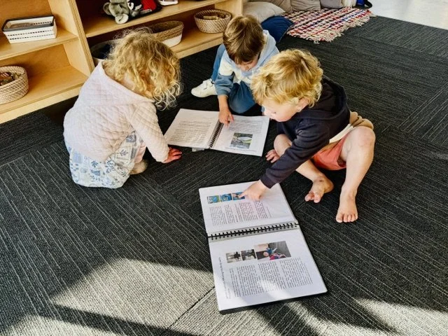 Children sharing books together, developing early literacy, language skills and a lifelong love of reading