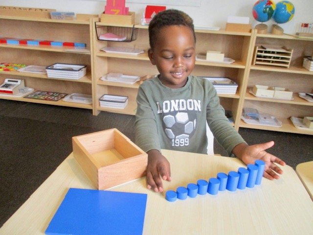 Child using Montessori counting materials to develop early numeracy skills, concentration and one-to-one correspondence.