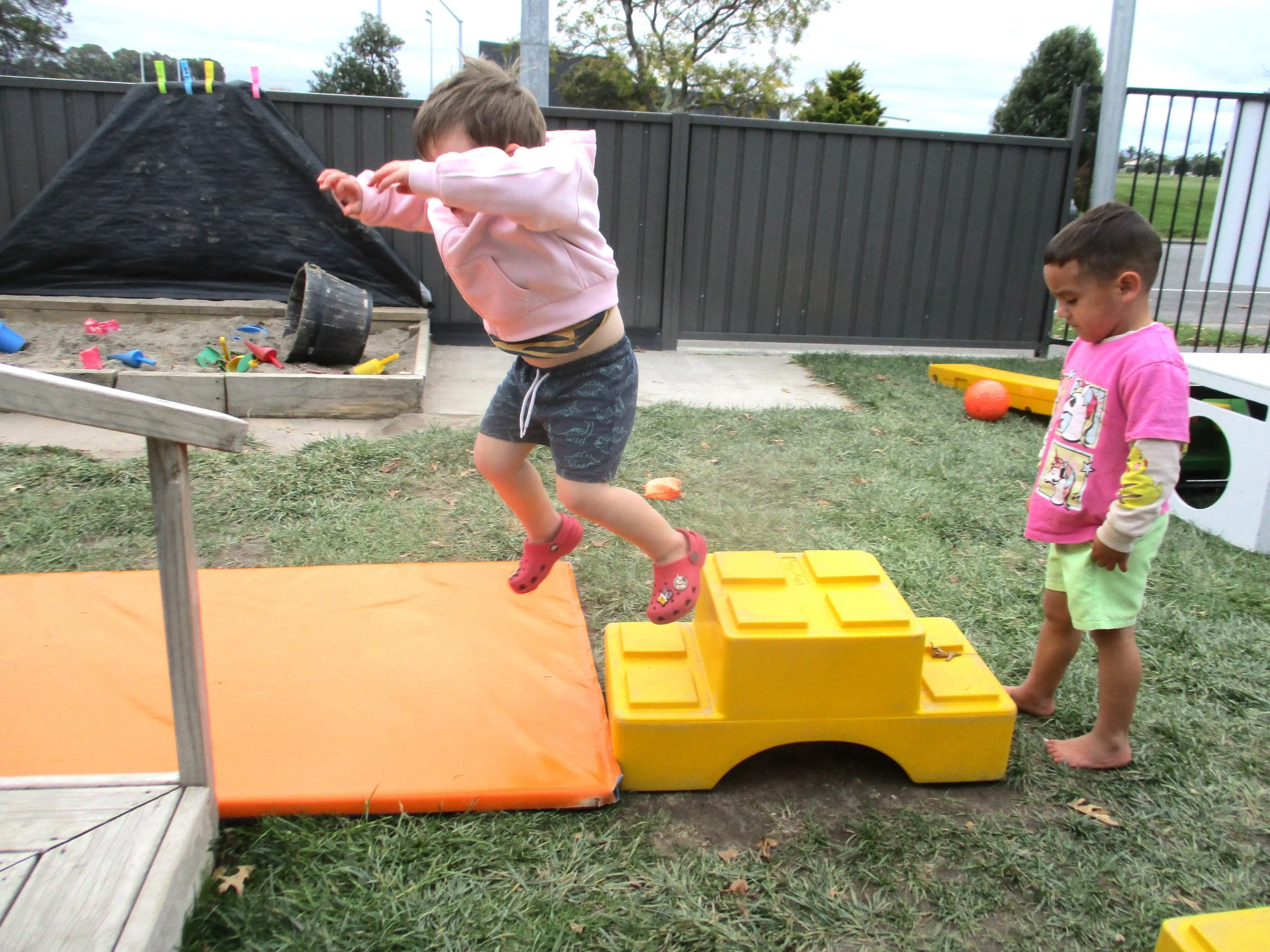 Children developing balance, coordination and confidence through active outdoor play and gross motor challenges.