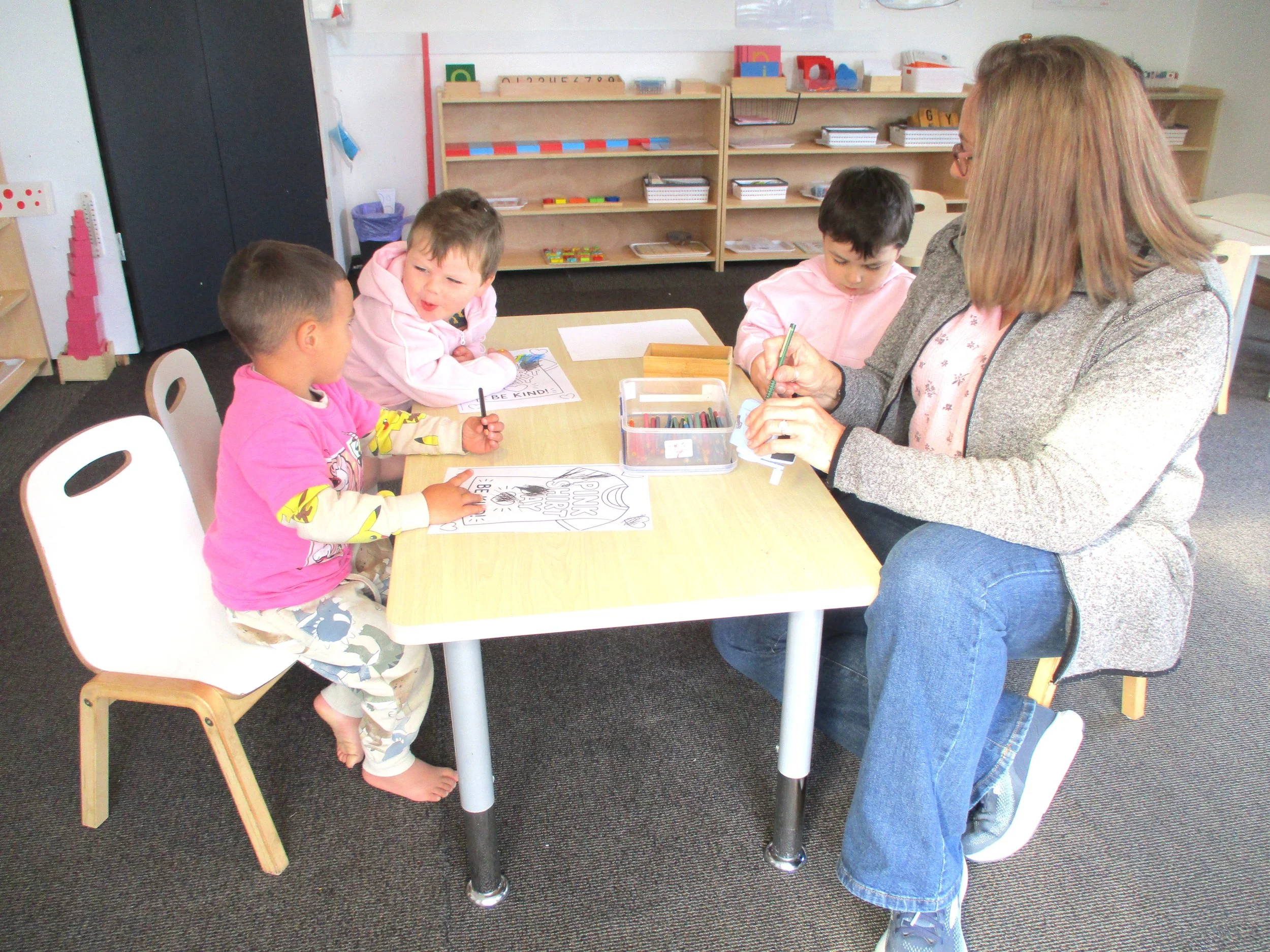 Teacher supporting children through creative experiences, encouraging self-expression, fine motor development and meaningful conversations.
