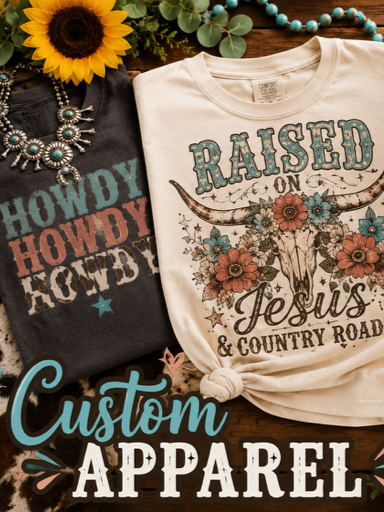 Two custom t-shirts with religious and country themes, one with a floral cow skull and the words "RAISED ON Jesus & COUNTRY ROAD," and the other with "HOWDY" in large letters. Flowers, jewelry, and a sunflower are also visible in the background.