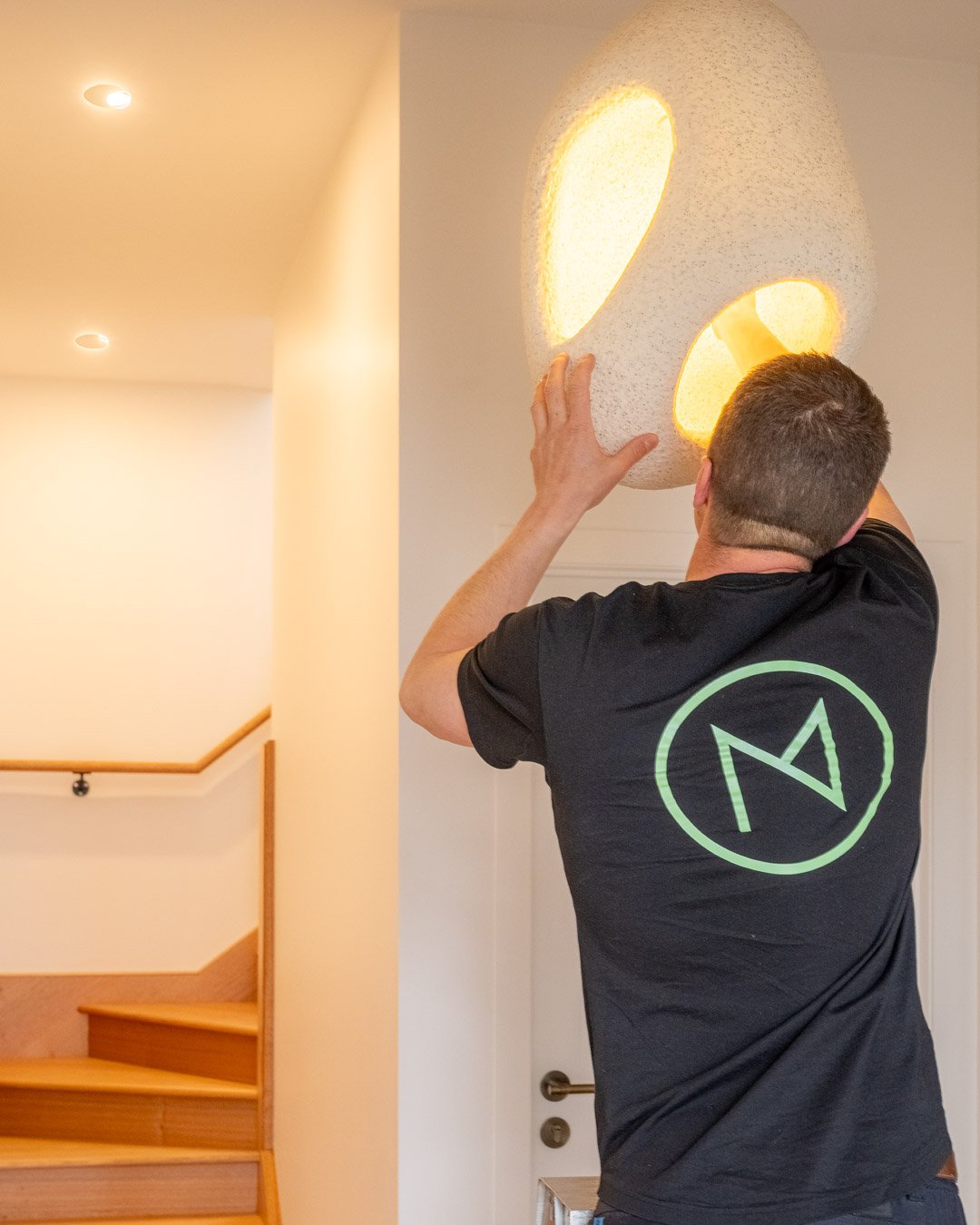 electrician fixing a light fixture