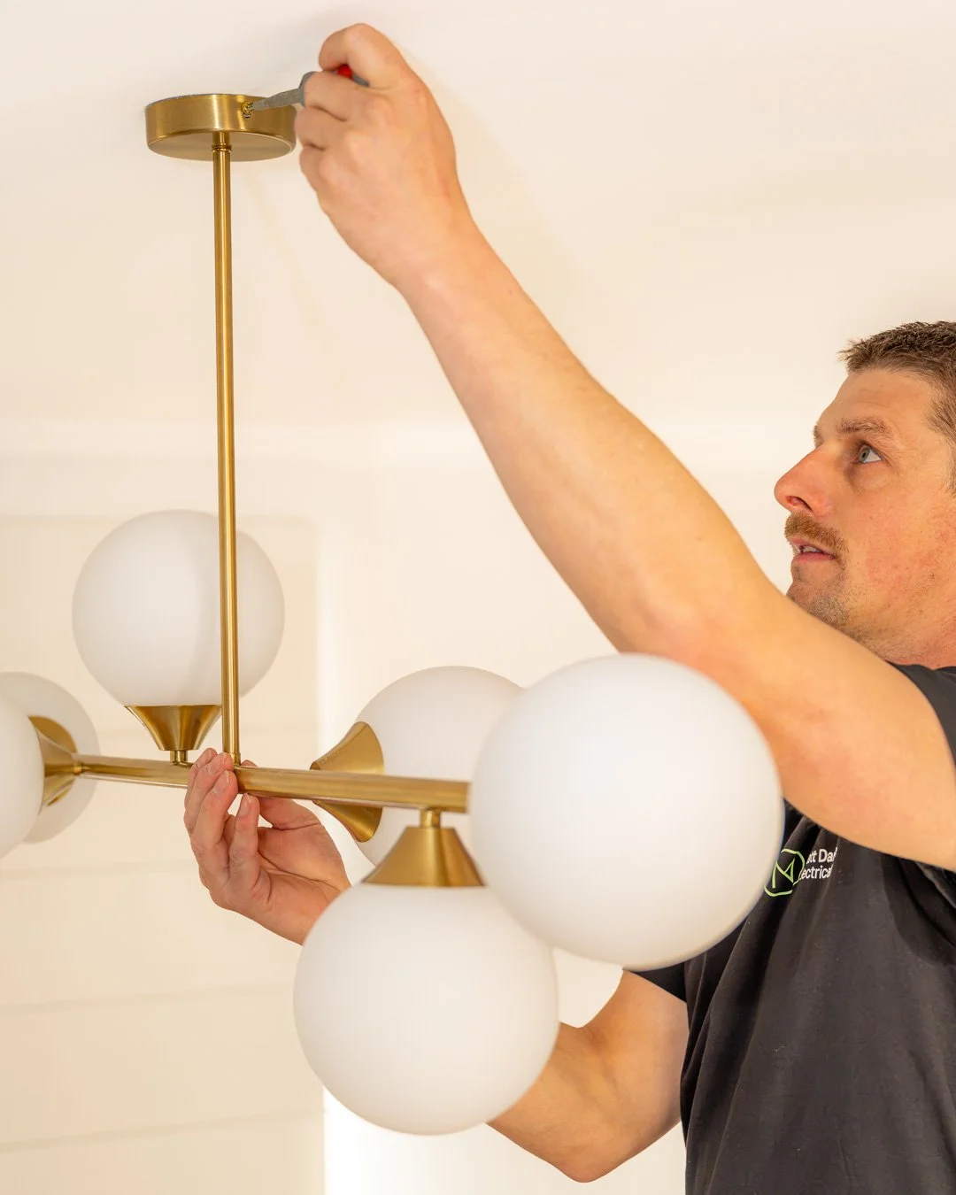 electrician installing a high quality light fixture