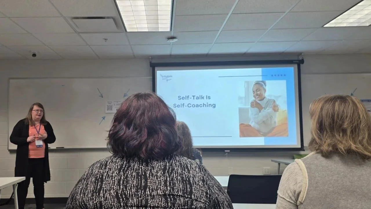 Michelle Pezley giving a presentation to an audience in a classroom or conference room.