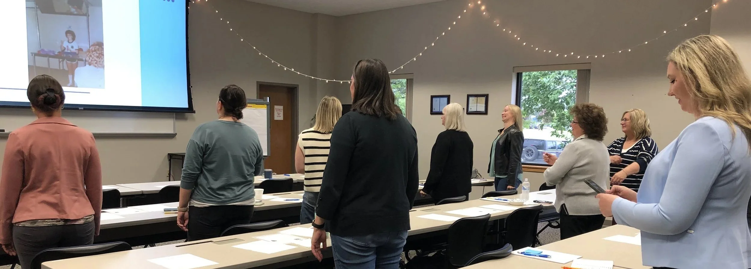 A group of women participating in a workshop activity on building confidence.