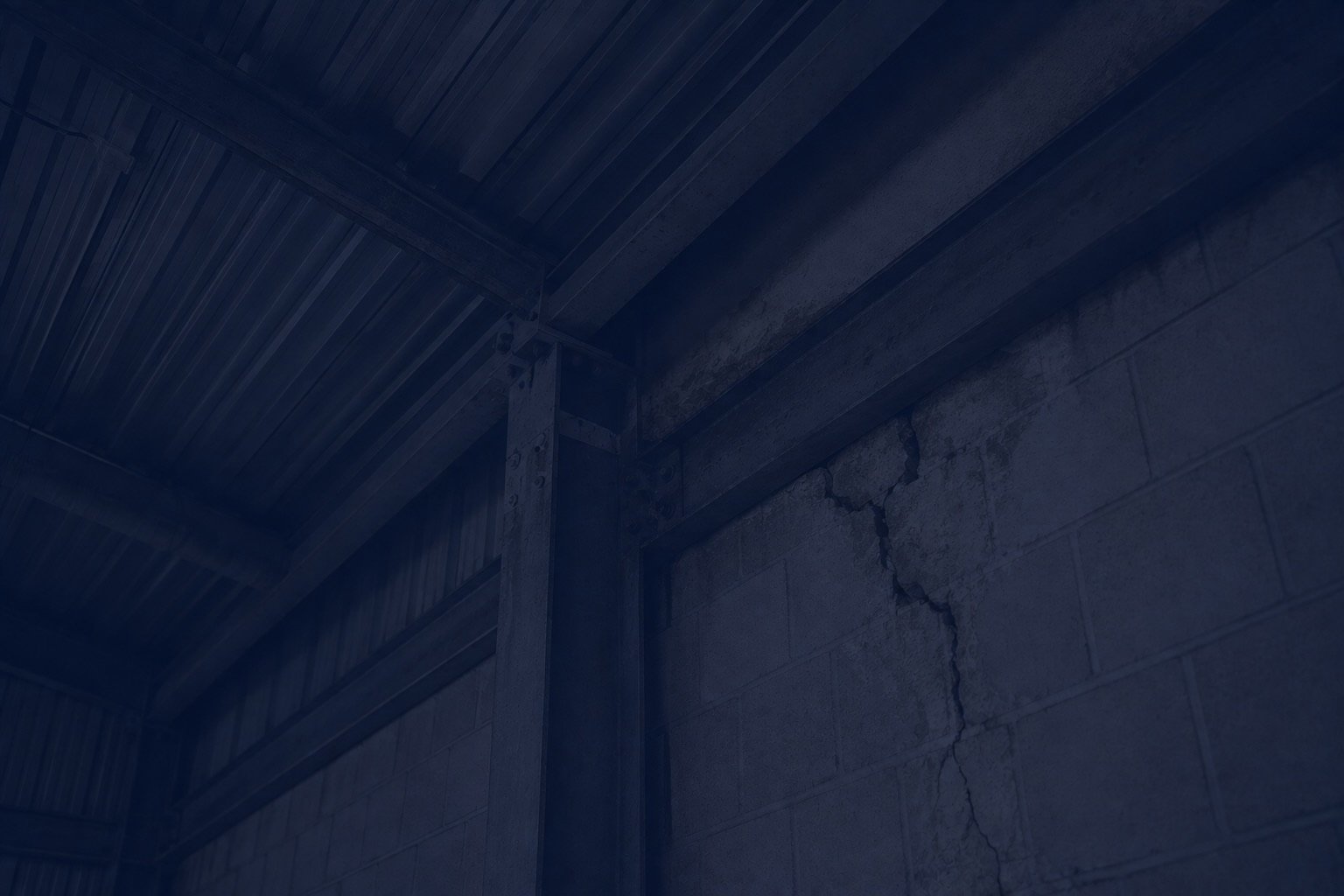 Concrete wall with a huge crack in it