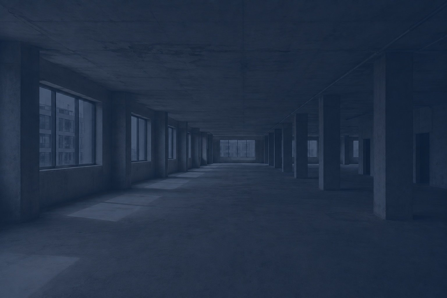 Open room with concrete floor, ceilings, and poles