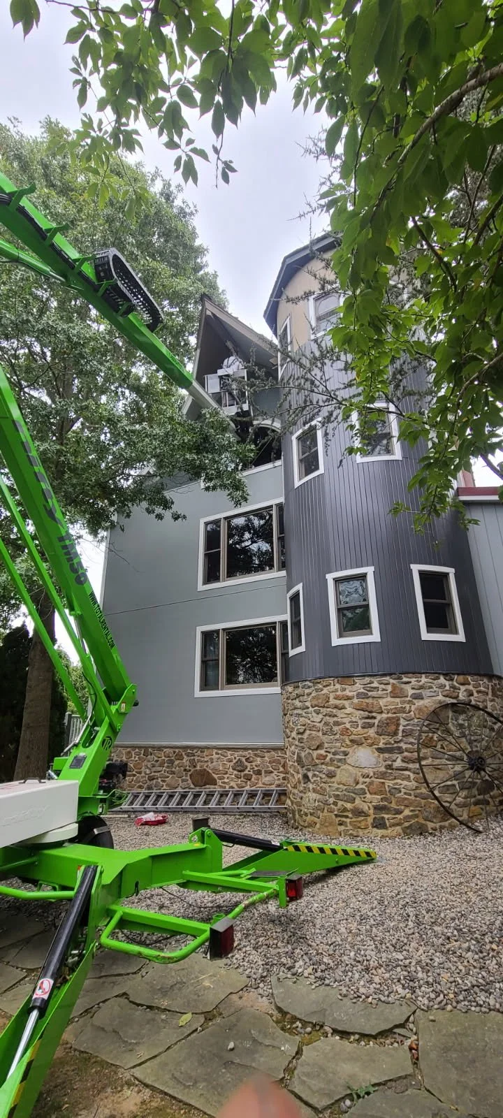 Professional painter in Chester Springs painting the exterior of a big house