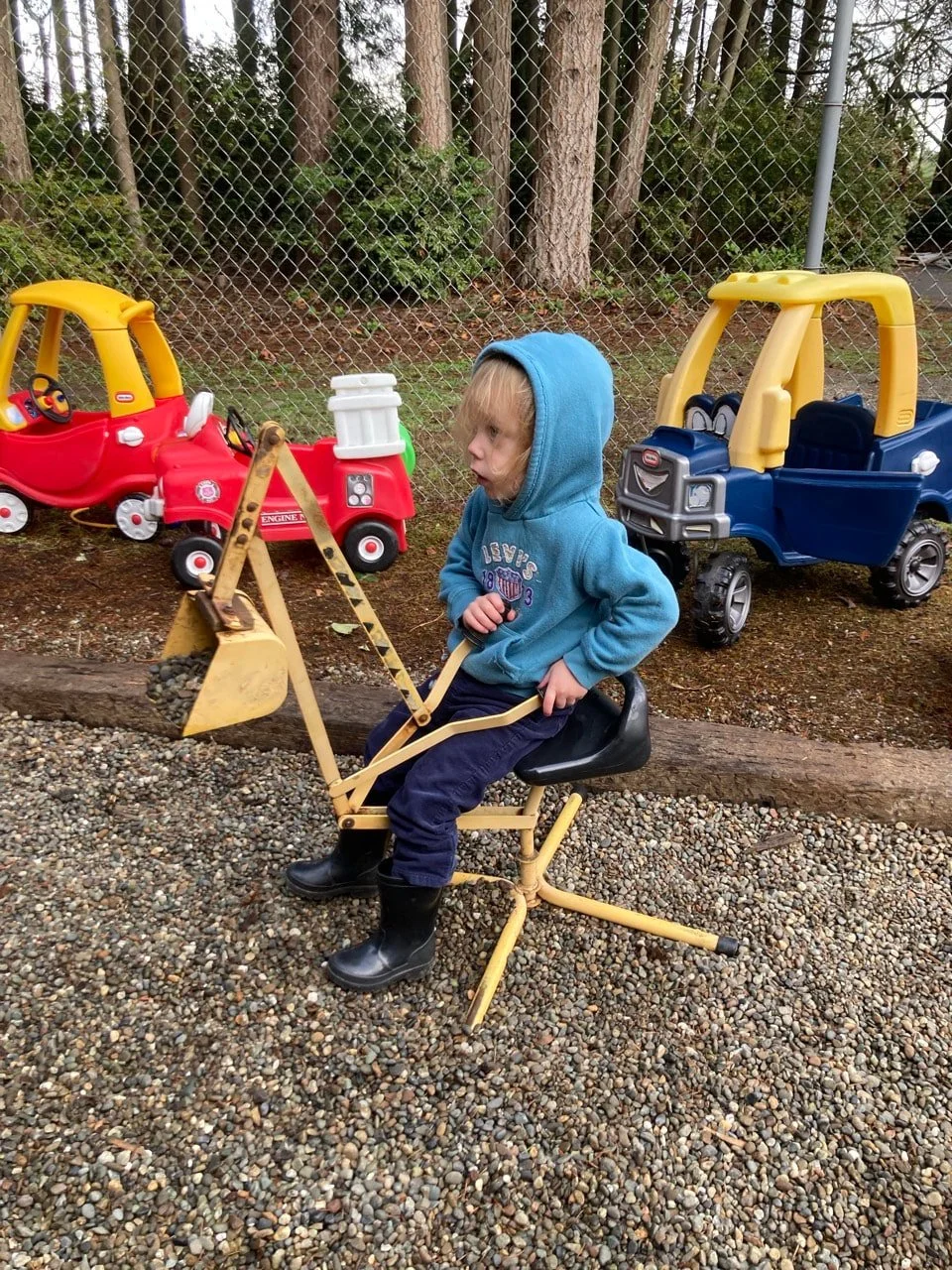 Child engaging in imaginative construction play on the playground.