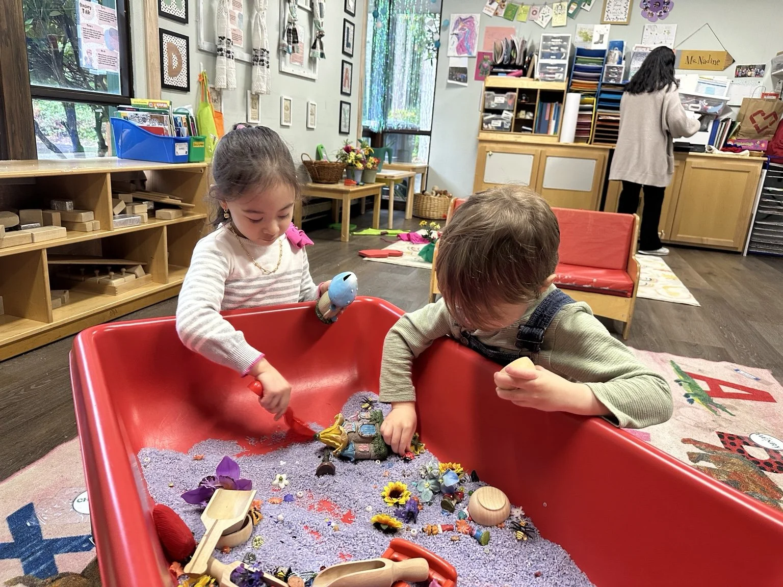 Children exploring a sensory bin through hands-on play.