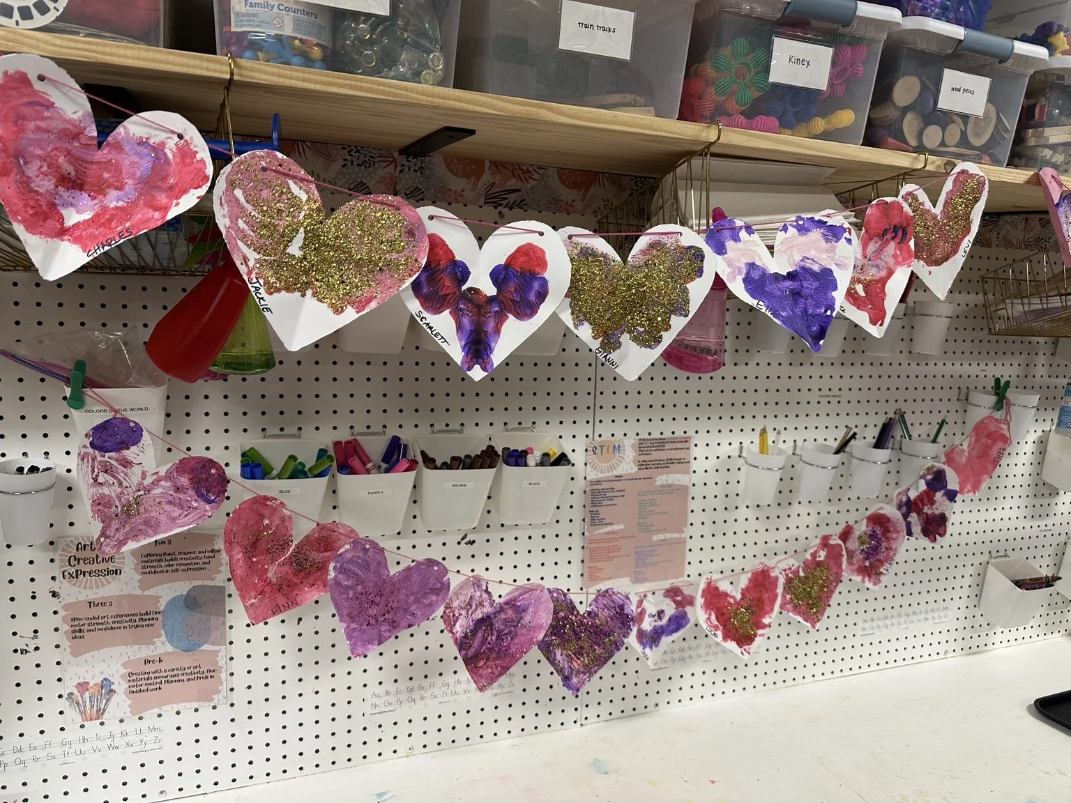 Children's Valentine's artwork displayed in the classroom.