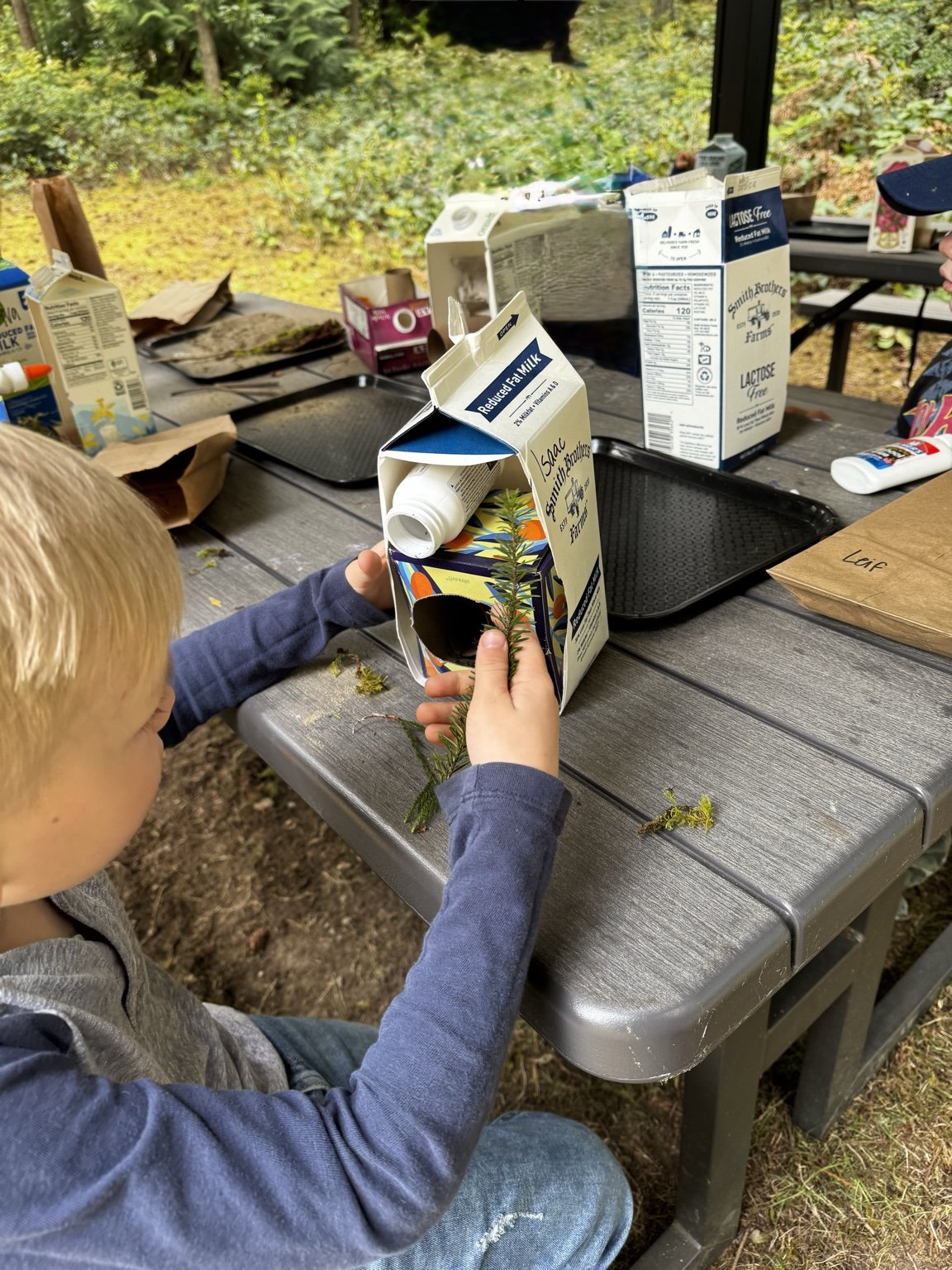 Child exploring nature through a hands-on wildlife habitat project.