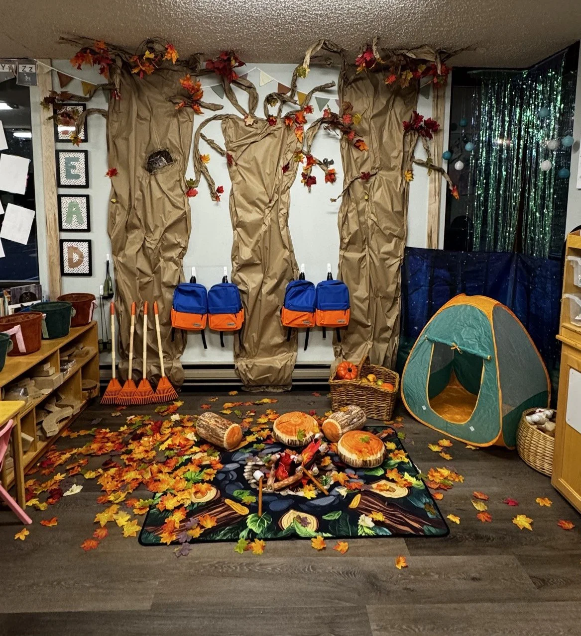 Inviting preschool classroom decorated for autumn themed learning and imaginative play.