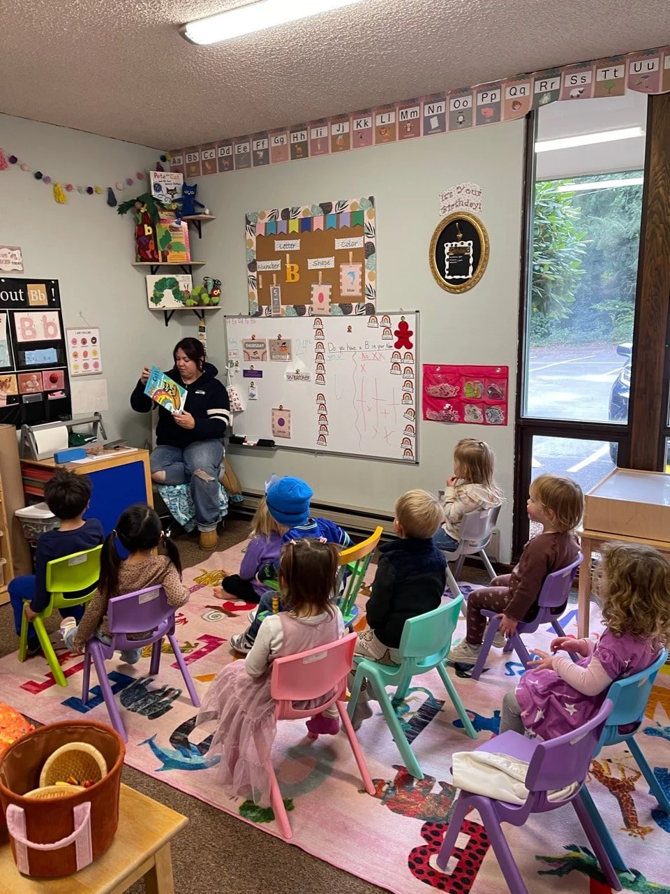 Pre-K children listening to a story during circle time.