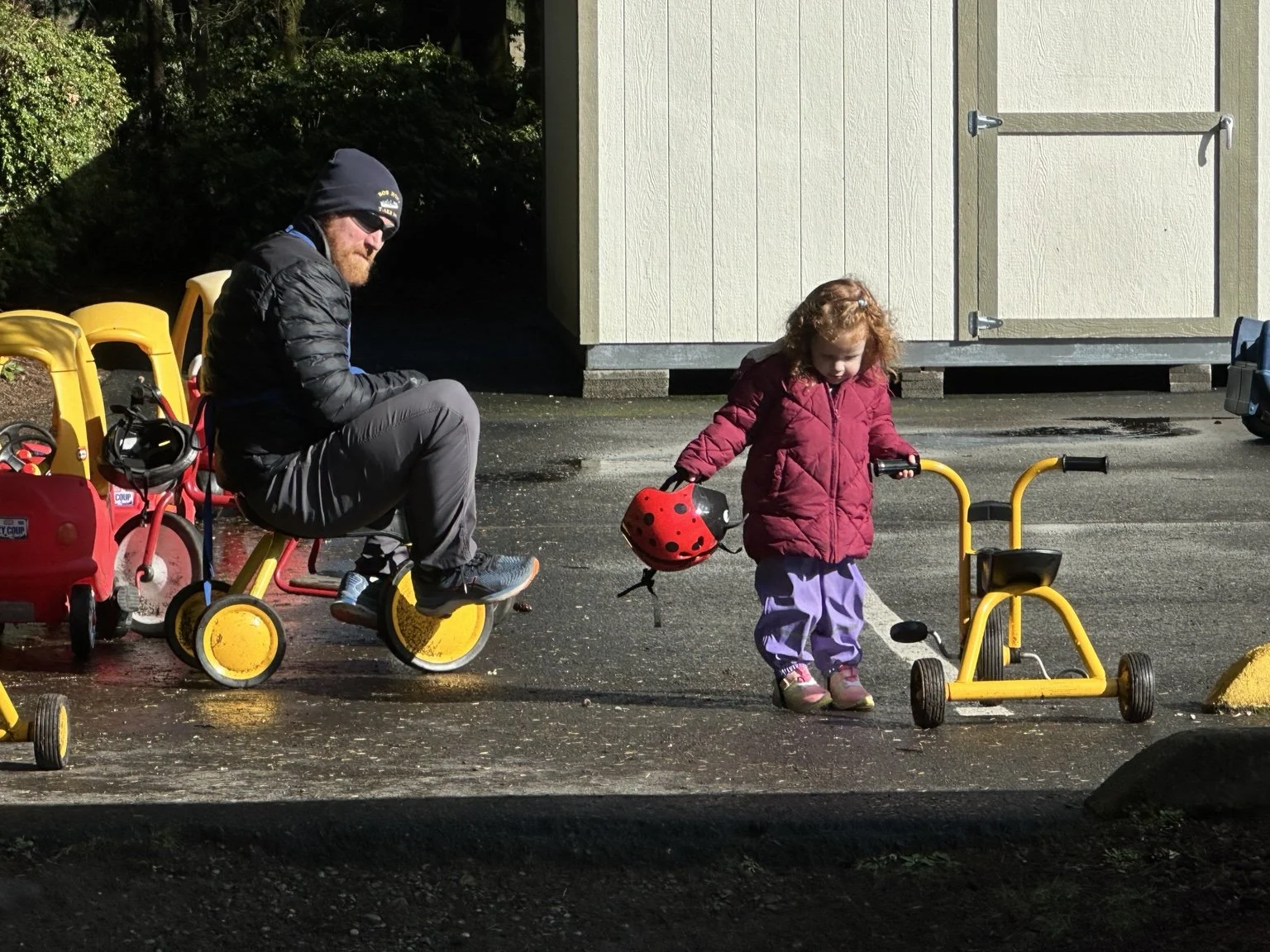 Parent and child enjoying outdoor play together.
