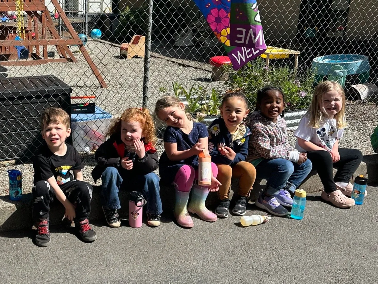 Preschool children enjoying outdoor time together at Gig Harbor Cooperative Preschool.