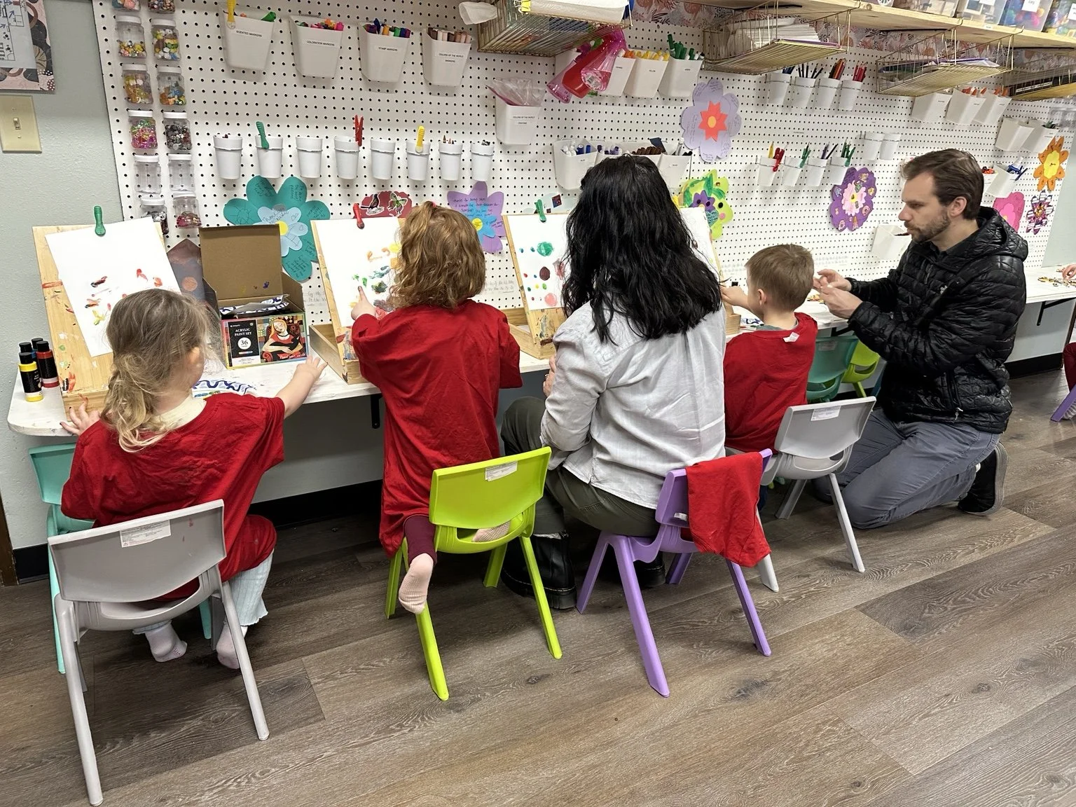 Families participating in a creative classroom activity together.