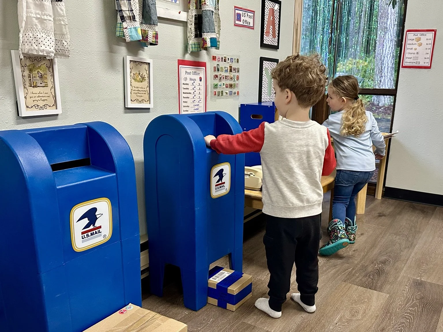Children engaging in imaginative post office dramatic play.