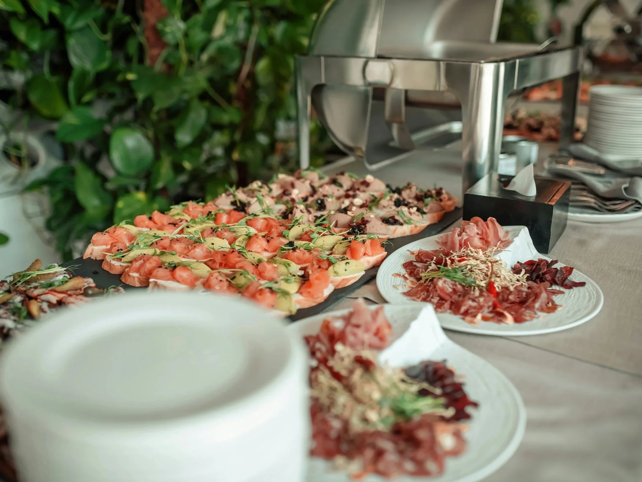 Freshly prepared corporate catering platter with gourmet sandwiches and wraps.