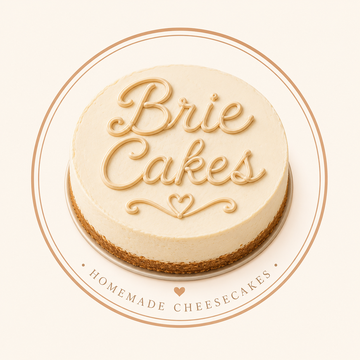 A round cheesecake with a smooth white topping and the words "Brie Cakes" written in beige icing on top. The cheesecake is on a white surface with a circular logo around it that reads "Homemade Cheesecakes" with a small heart in the center.