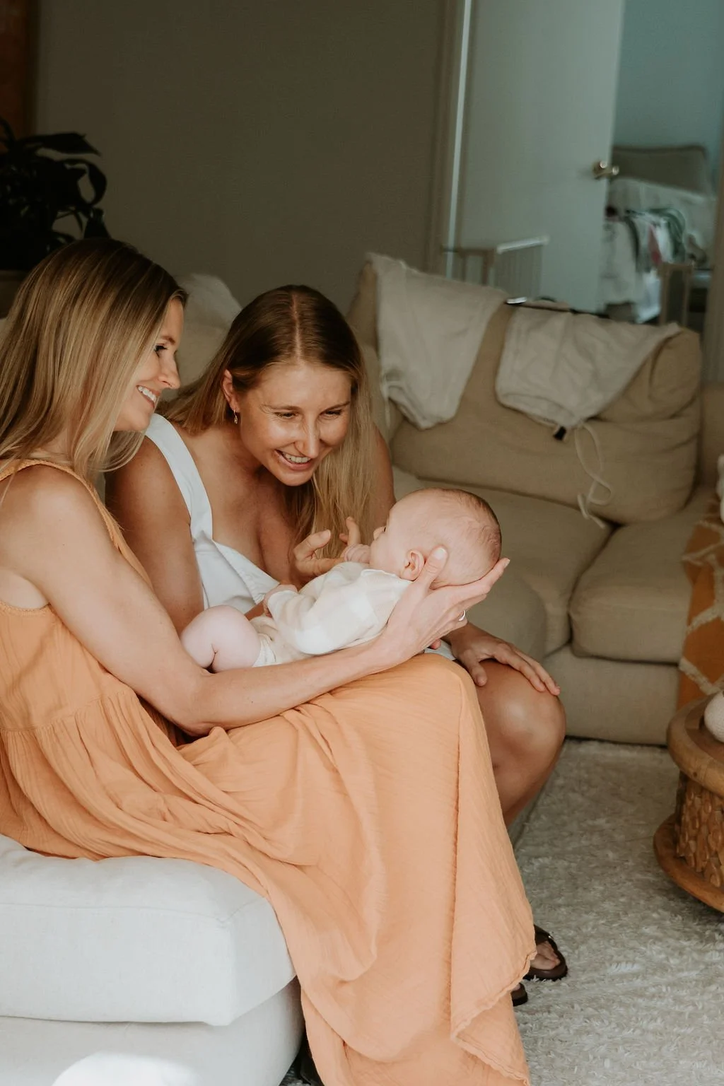 Lactation consultant supporting mother with breastfeeding at home on the Sunshine Coast