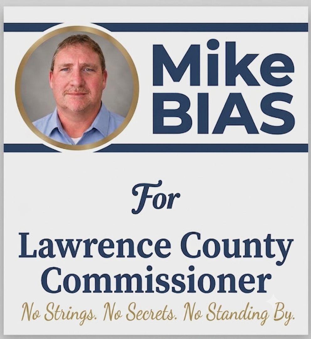 Campaign sign with a photo of Mike Bias and text showing his candidacy for Lawrence County Commissioner. The sign includes a slogan: No Strings. No Secrets. No Standing By.