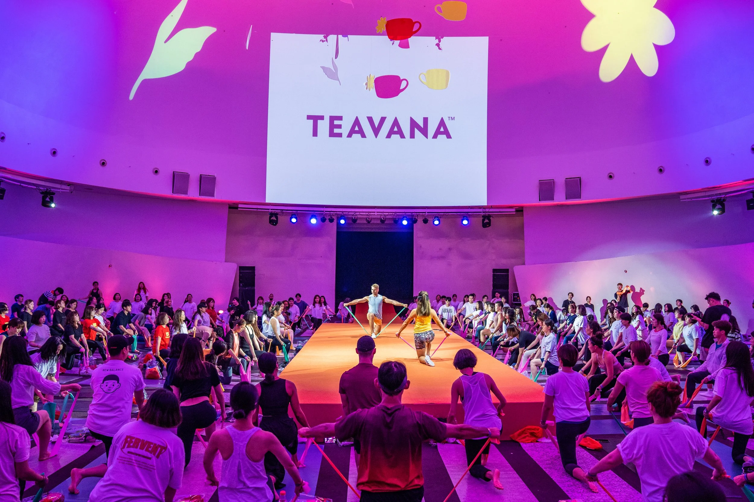 Corporate wellness event hosted for TEAVANA and lululemon — PowerSweat Korea group session with employees in an auditorium setting