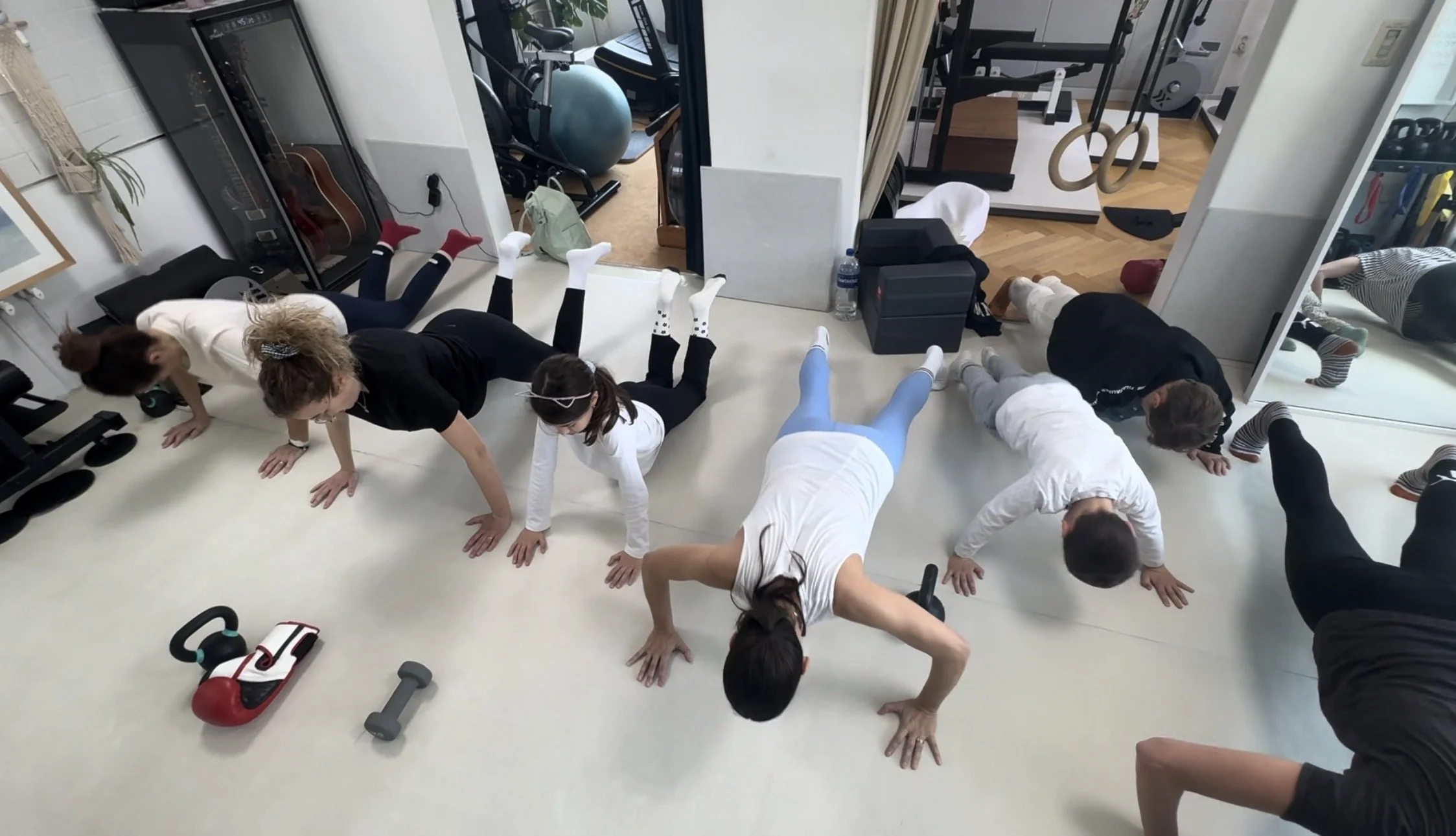 Class led by PowerSweat Korea coach Dean at DNA Studio— clients practicing push-ups and yoga.