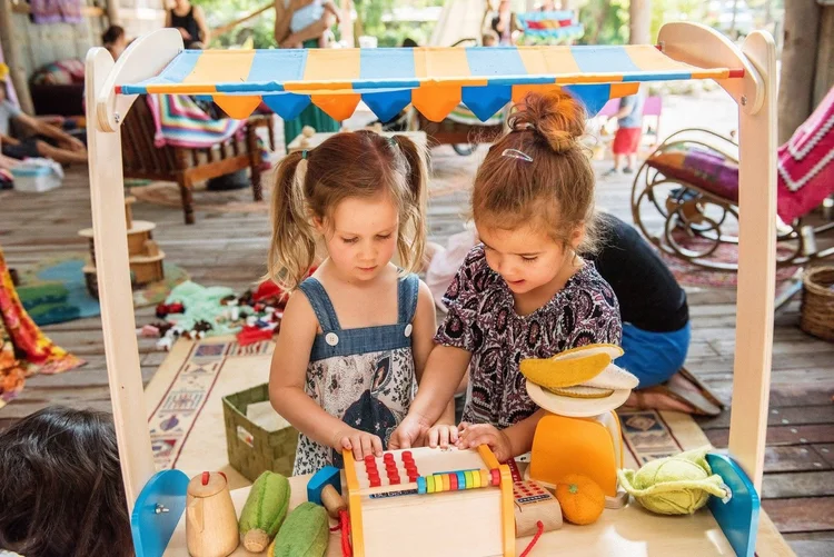 Children playing at a market stall