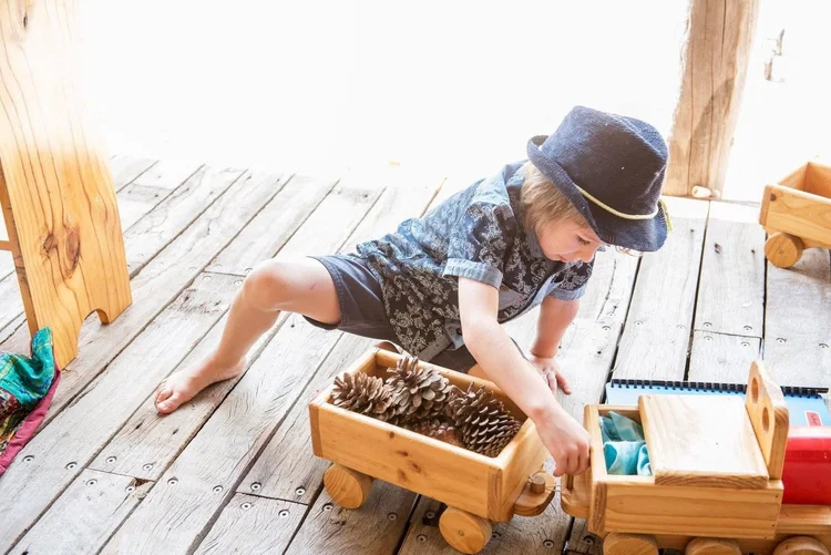 Child playing with pinecones