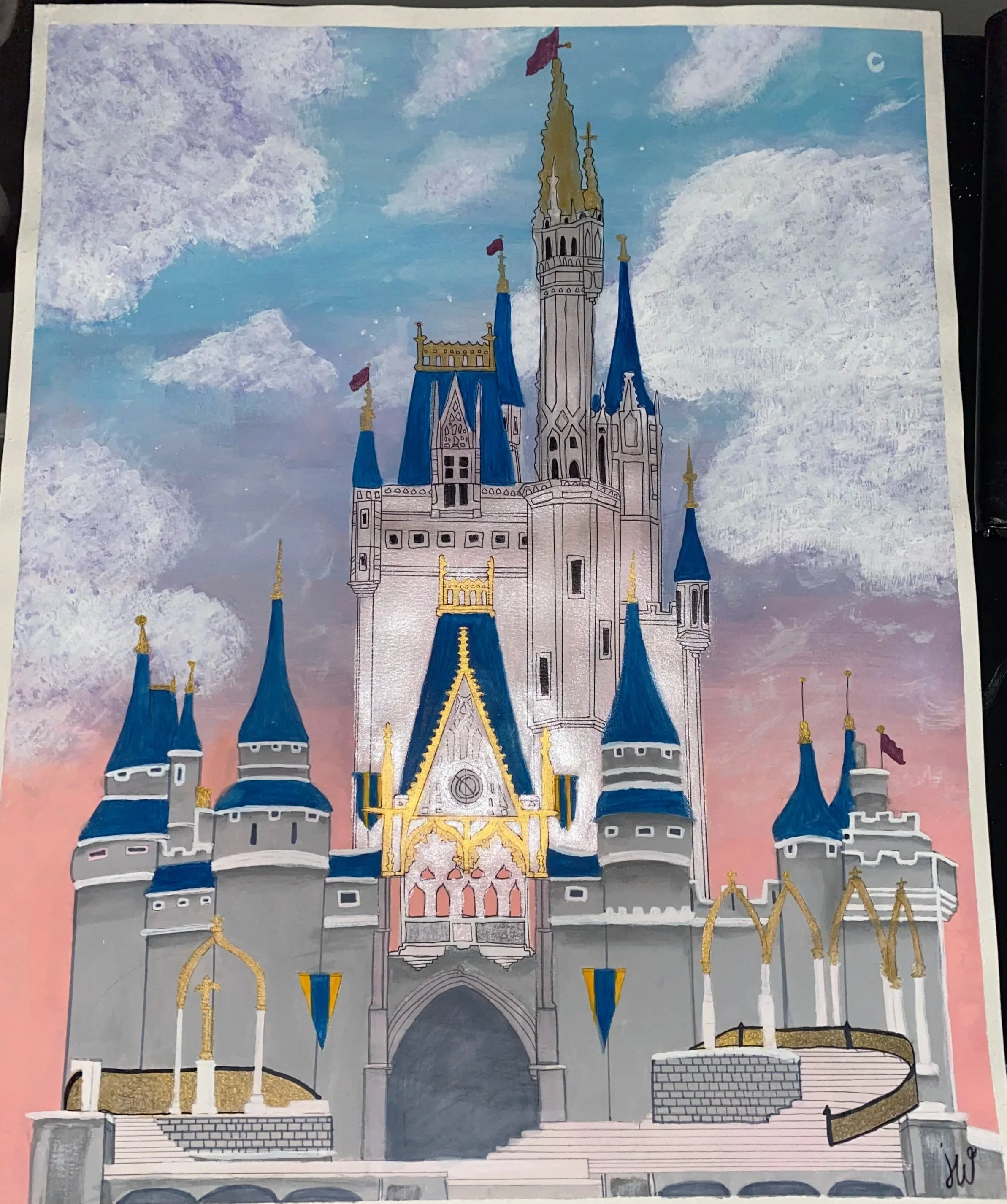 A colorful illustration of a castle with blue and gold accents, tall spires with flags, and a grand entrance, set against a pink and blue sky with clouds.