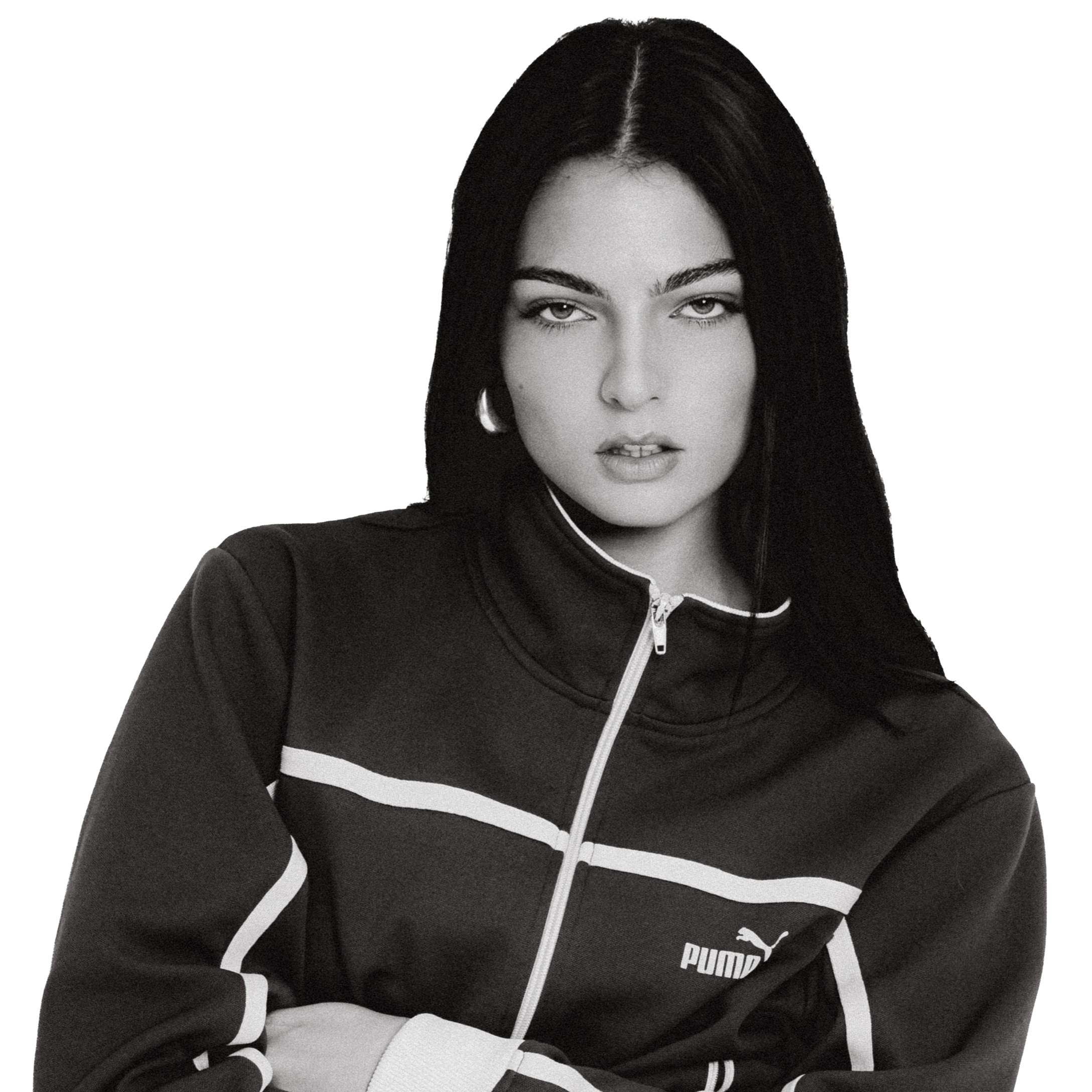 Black and white photo of a woman with dark hair and a serious expression, wearing a black Puma sports jacket with white accents.