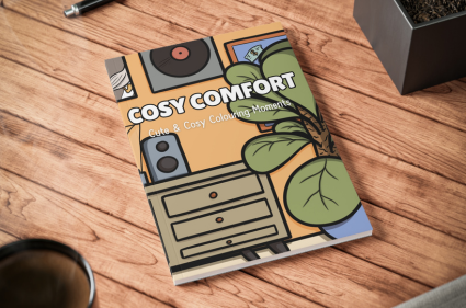 Mockup of the Cosy Comfort colouring book lying closed on a table