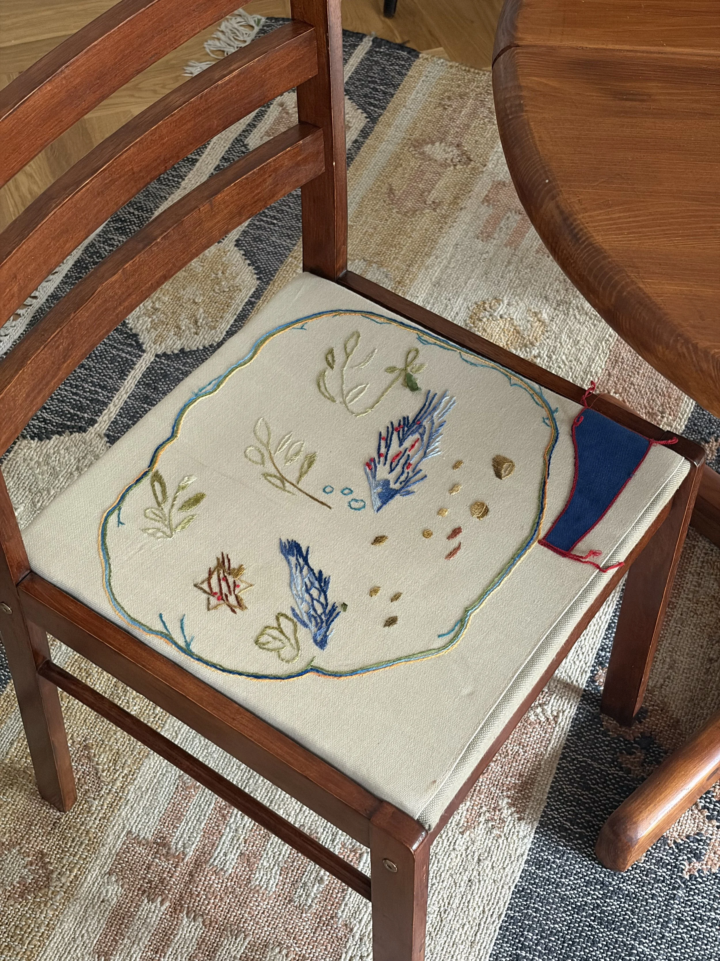 hand embroidered upholstery on a restored wooden chair