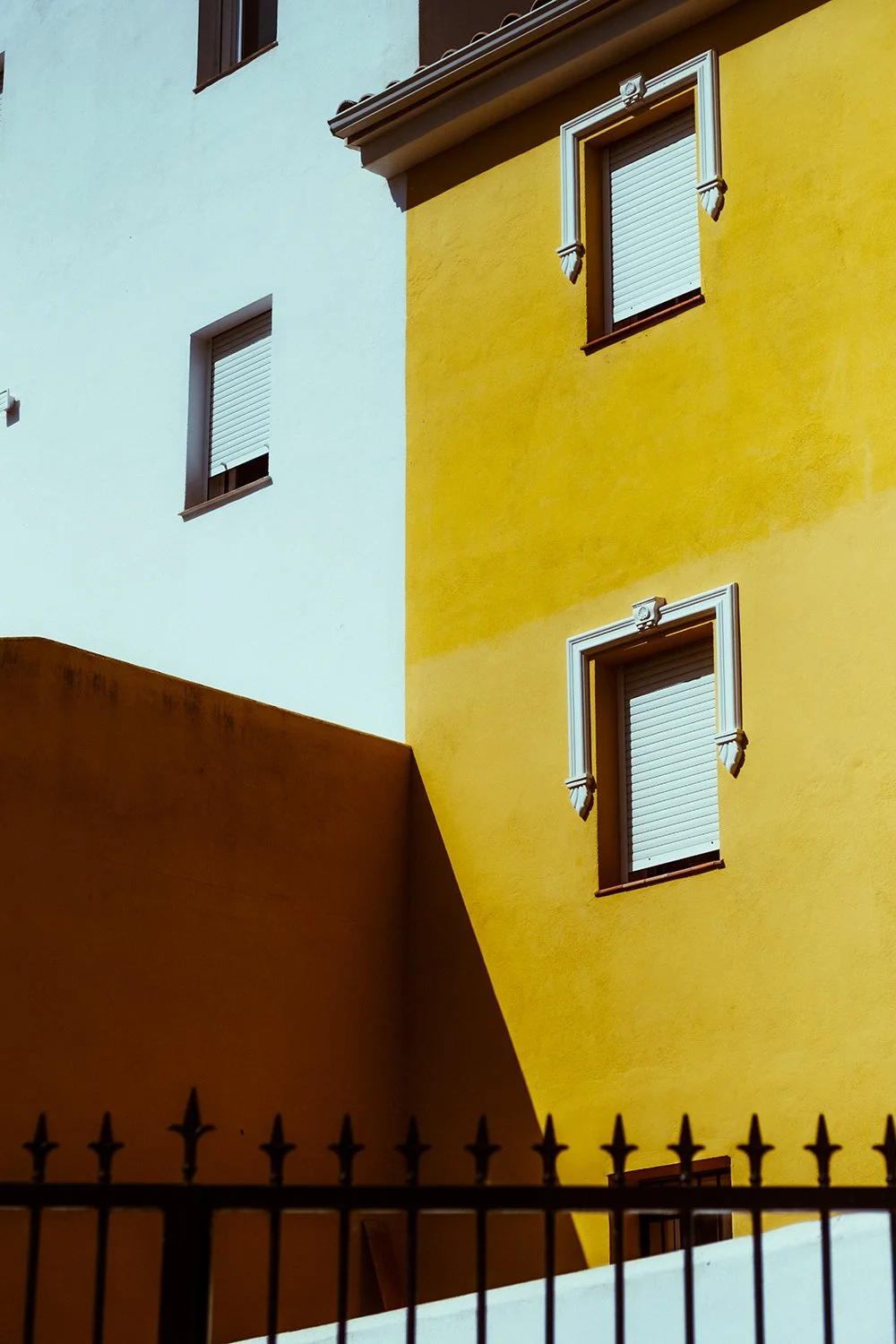 Yellow house and a fence in Spain