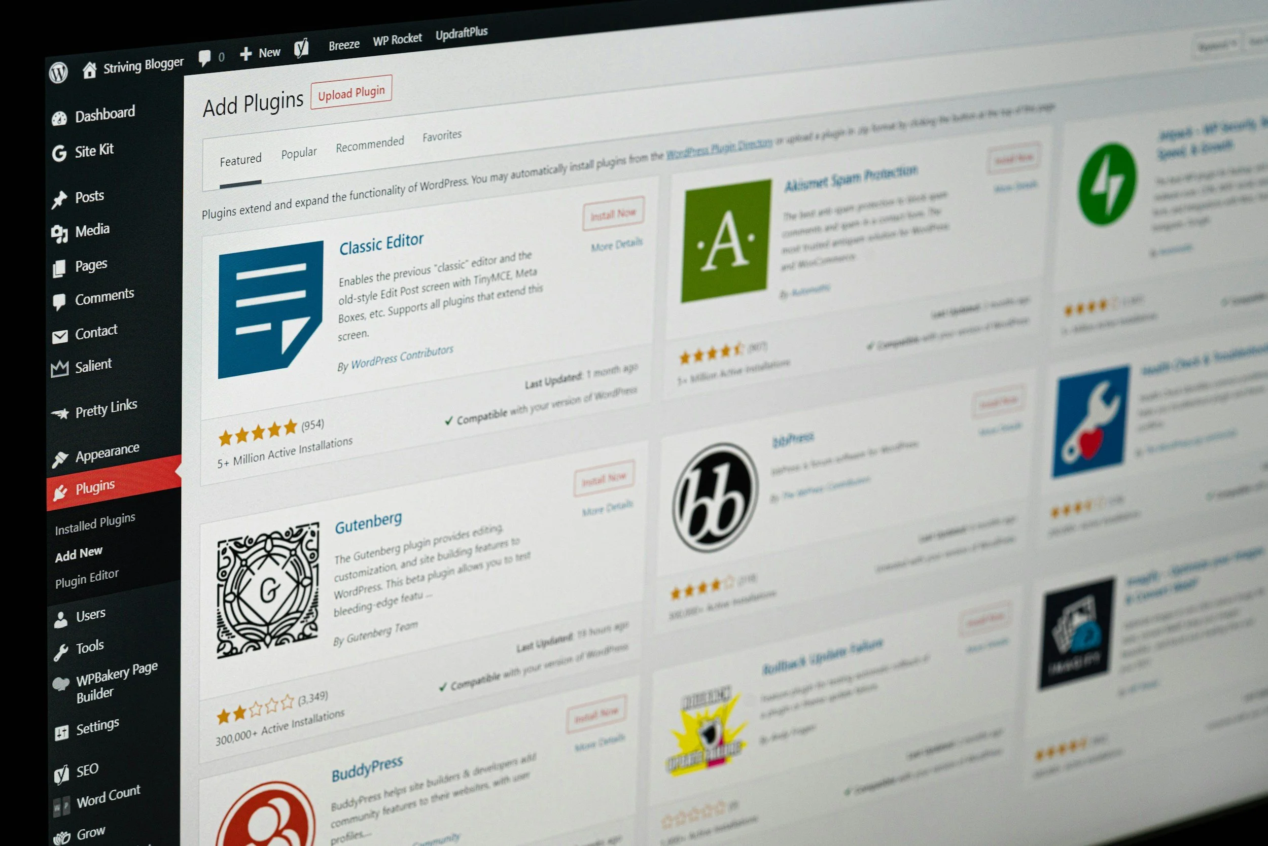 Screenshot of a WordPress dashboard page displaying the 'Add Plugins' section with various plugins, their icons, names, ratings, and descriptions, along with the left-hand menu showing options like Dashboard, Posts, Media, Pages, and Plugins.