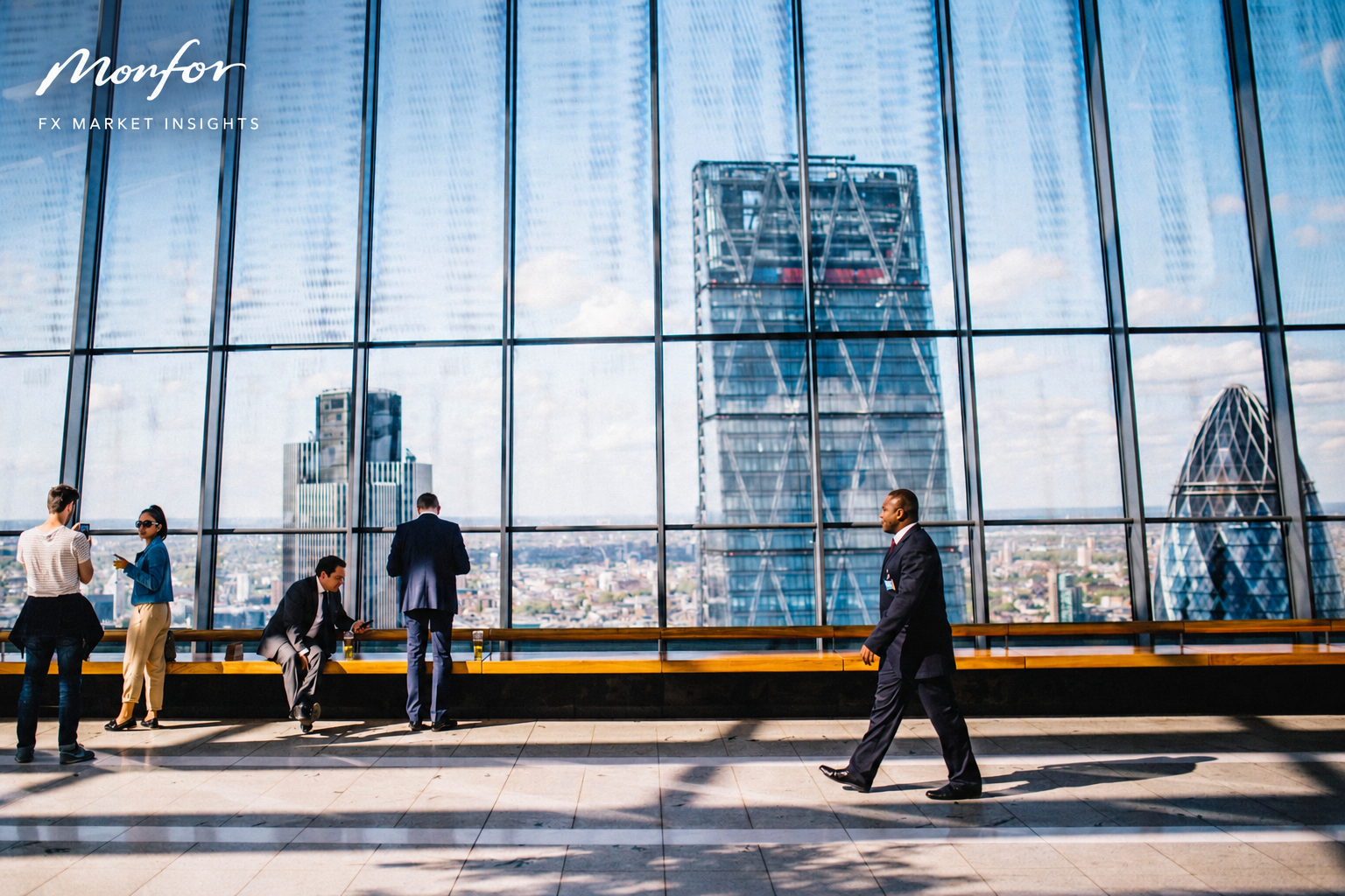 Monfor FX Market Insights overlooking the London financial district, with business professionals inside a modern glass office and the City of London skyline in the background, including the Gherkin and surrounding skyscrapers.