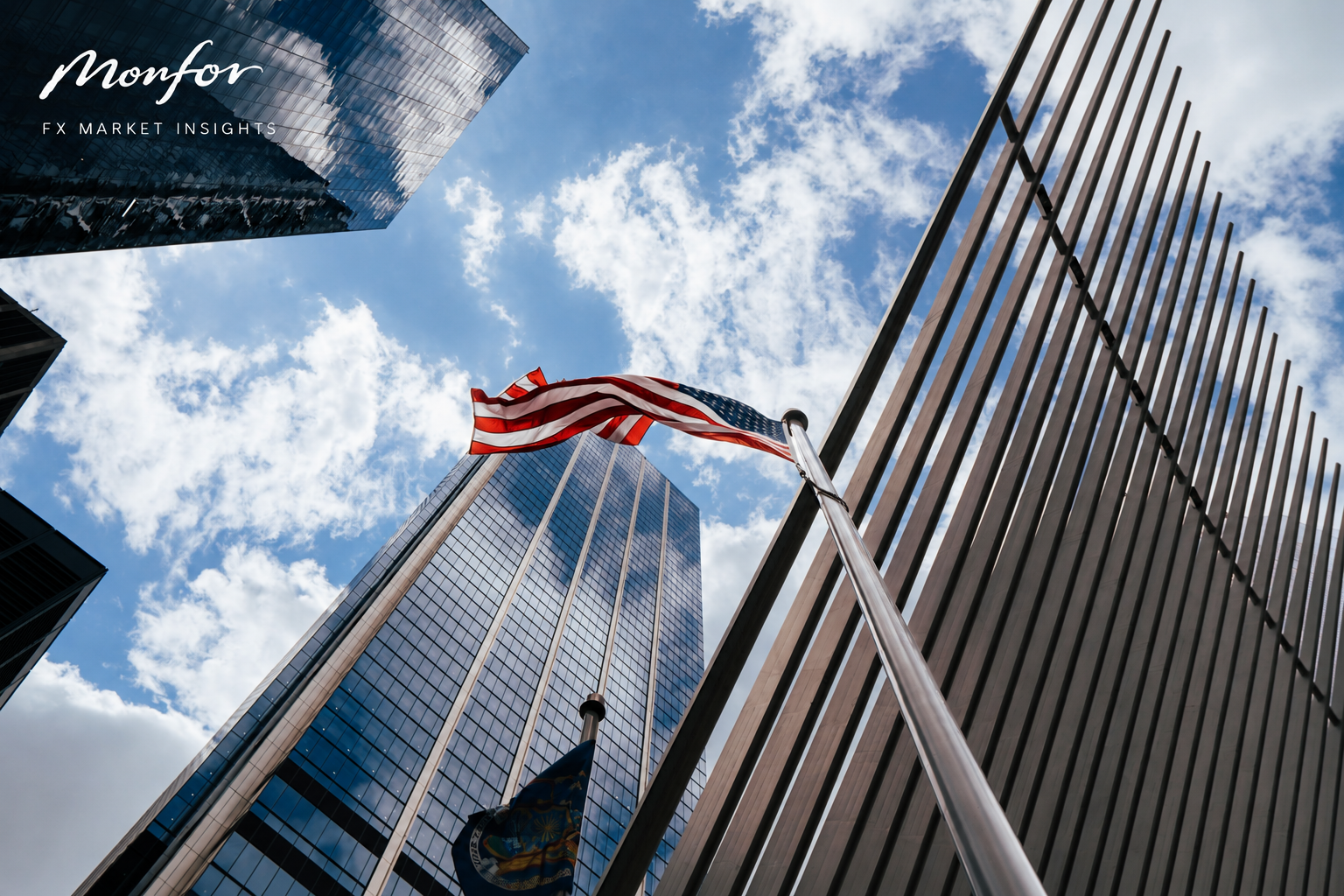 American flag flying between modern skyscrapers in a financial district, branded with Monfor FX Market Insights.