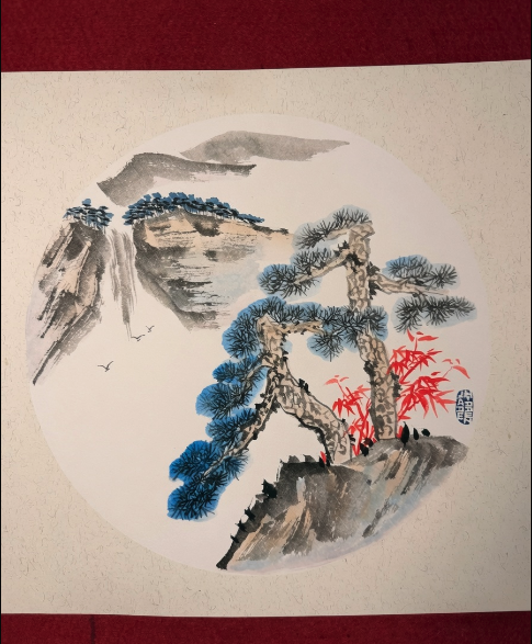 Traditional East Asian brush painting featuring cranes, pine trees, mountains and red foliage in a circular composition.