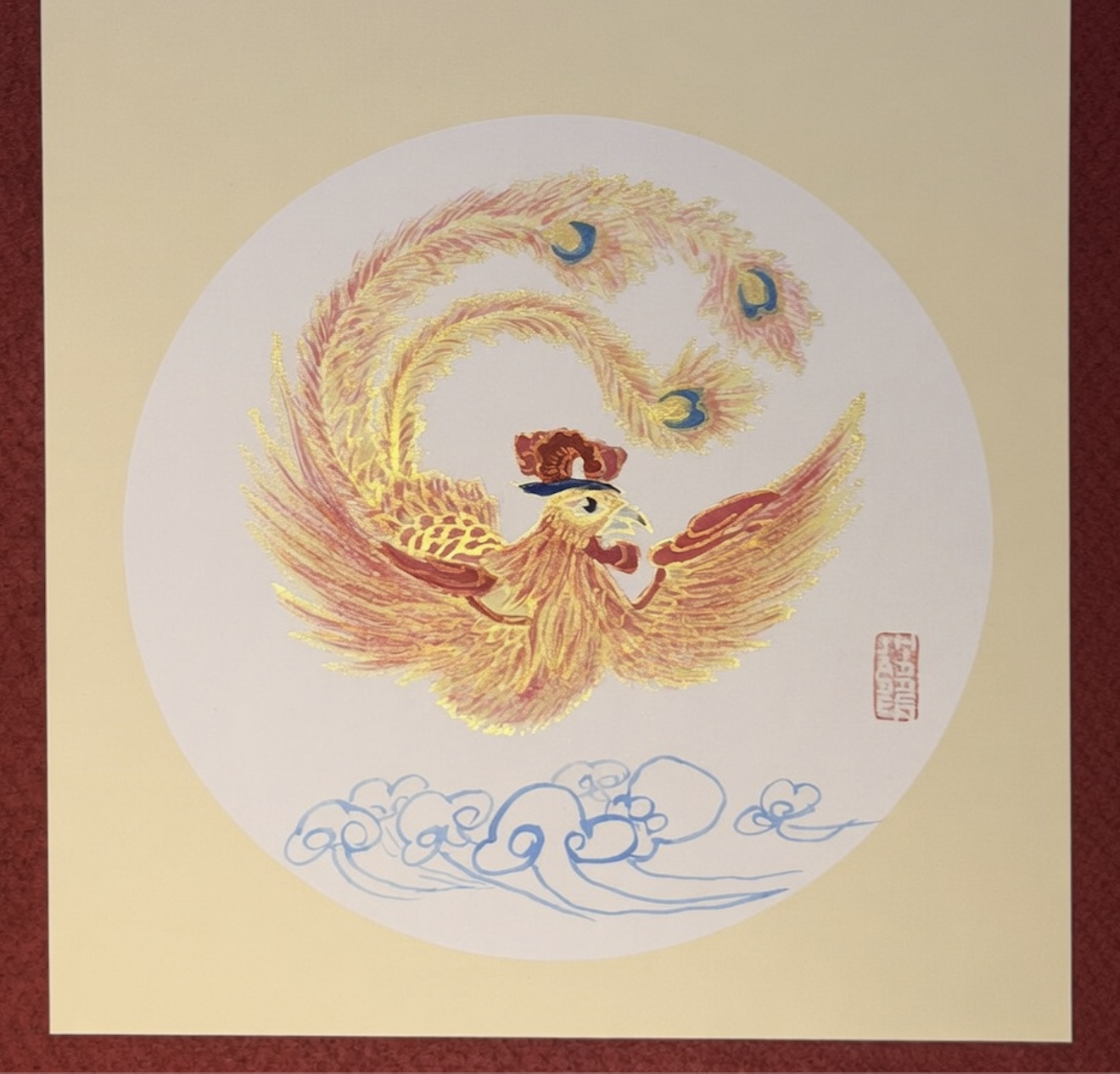 An illustration of a mythological phoenix with golden and red feathers, flying above stylized blue clouds, surrounded by a circular white background and bordered by a beige and red frame.